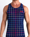 Front view of model wearing the BJORN THIS WAY (BLACK) men’s beach tank top in a white color with rainbow stripes by the Bang! Clothes brand of men's beachwear from Miami.