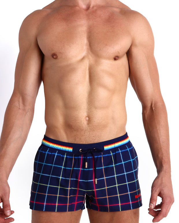 Front view of model wearing the BJORN THIS WAY (DARK) men’s beach shorts inspired iconic P.L. Rolando&