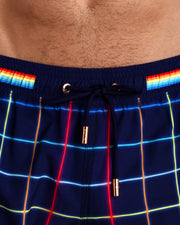 Close-up view of the BJORN THIS WAY (DARK) men’s summer shorts, showing black cord with custom branded golden cord ends, and matching custom eyelet trims in gold.