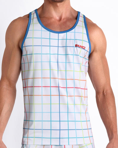 Front view of model wearing the BJORN THIS WAY men’s beach tank top in a white color with rainbow stripes by the Bang! Clothes brand of men's beachwear from Miami.