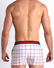 Back view of male model wearing the BJORN TO BE ALIVE beach trunks by iconic P.L. Rolando's Saleti Settanta Bjorn Borg FILA tennis shorts for men by BANG! Miami. Inspired by the Barbie movie SoBe/Art-Deco-inspired.