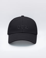 Front view of the BLACK Chillax Cap, showcasing the bold DC2 logo embroidered in black on the front panel. The cap features a sleek design with a curved brim and clean lines, made from premium black fabric.