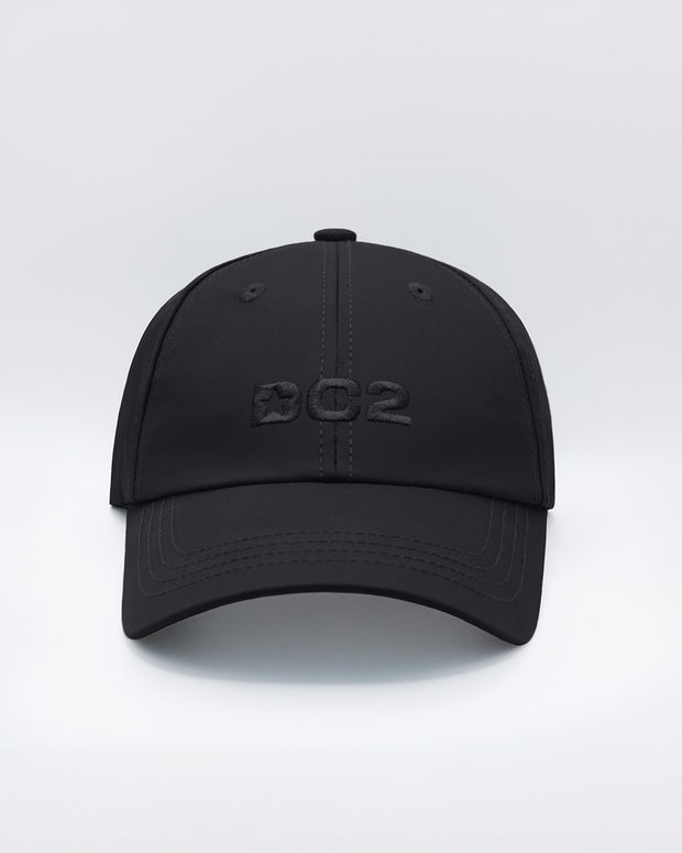 Front view of the BLACK Chillax Cap, showcasing the bold DC2 logo embroidered in black on the front panel. The cap features a sleek design with a curved brim and clean lines, made from premium black fabric.