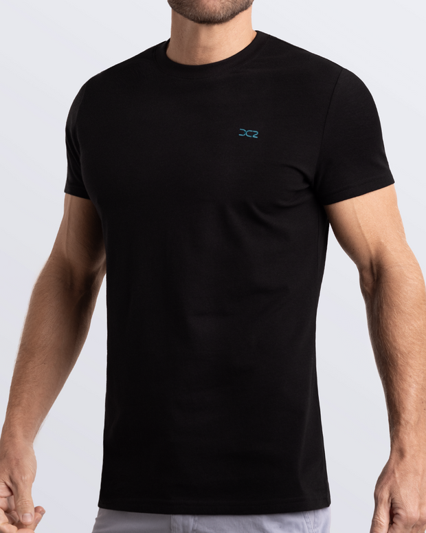 Frontal view of a male model wearing a black Pima cotton t-shirt, crafted for stylish casual wear and beachwear by DC2 Miami. Premium quality men&