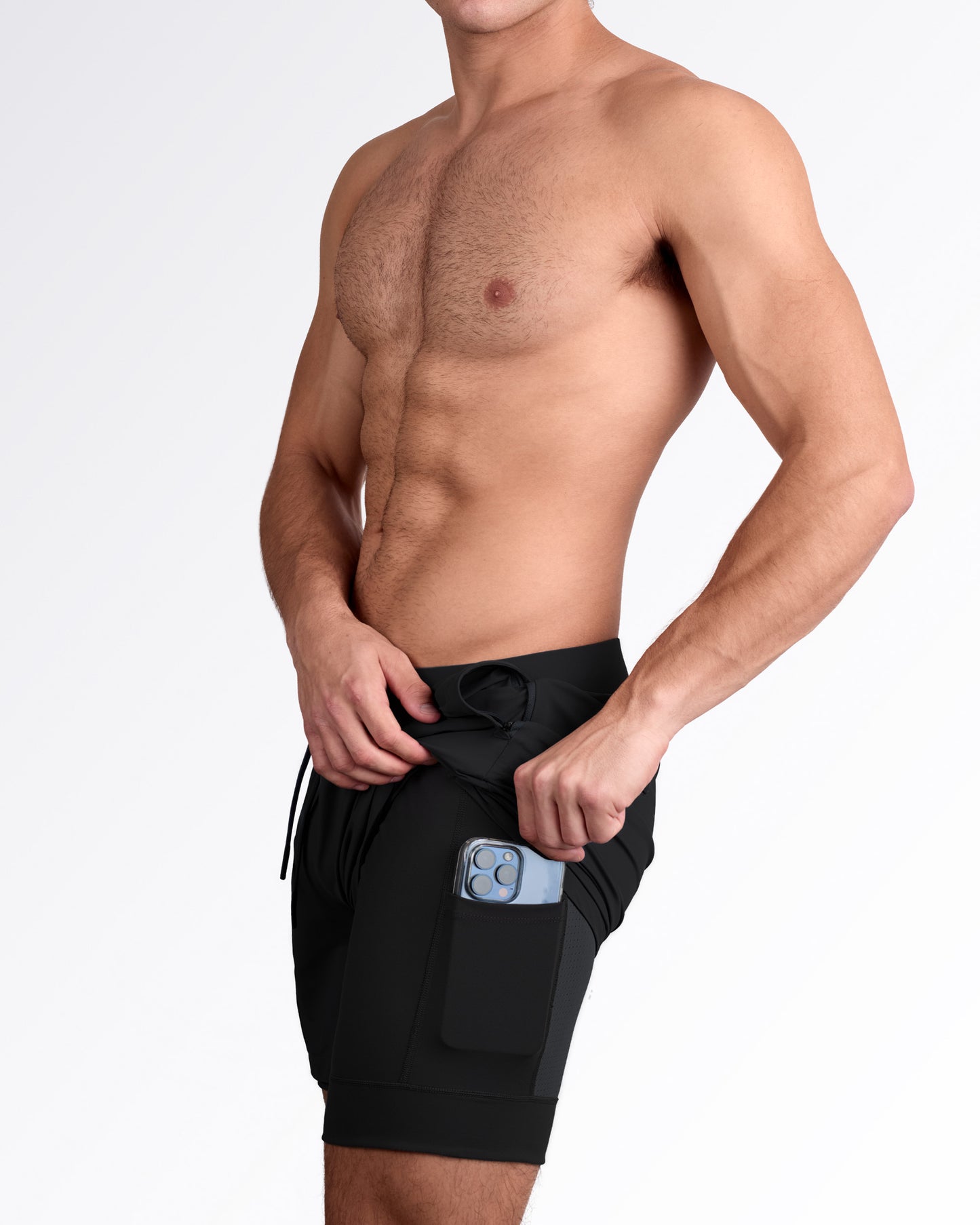 Showing internal pocket to store and carry smartphone in black gym workout shorts for men.