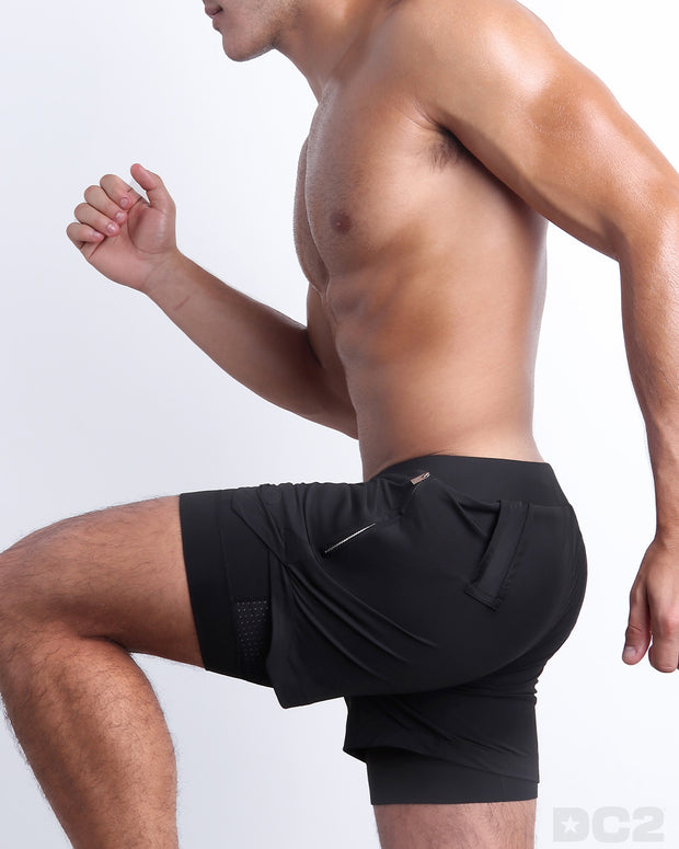 Side view of men’s performance exercise shorts in a solid black color made made by DC2 the official brand of mens sportswear.