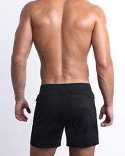 Back view of the BLACK men's fitness compression lined workout shorts in a dark black color. These premium quality quick-dry endurance shorts are DC2 by BANG! Clothes, a men’s beachwear brand from Miami.