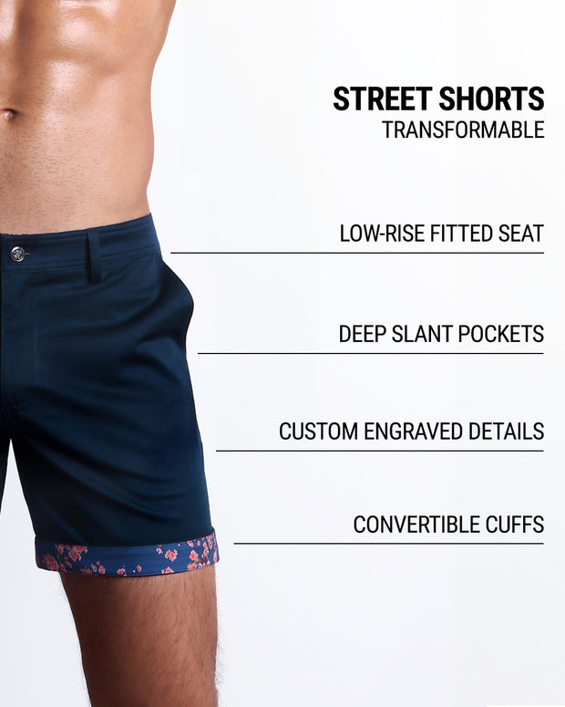 Men tailored fit chino shorts in BLOOMING BLUE by DC2 Keeps you feeling comfortable and looking sharp all. Classic chino shorts for men in a cotton blend from DC2 Clothing from Miami. Features two front pockets and custom engraved button front closure with zip fly. Can roll-up cuffs for shorter length and showing internal print. Or hem down for a mid-thigh length and full-solid dark blue color showing.