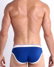 Back view of model wearing the BLUE AMBITION from the Retro line Men’s breathable cotton briefs in a dark blue color for men by BANG! Offers light compression for perfect contouring to the body and second-skin fit.