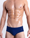 DC2 Spring/Summer 2025 collection — model wearing BLUE BY THE OCEAN swim briefs, in a crisp deep blue tone with a clean low-rise fit.