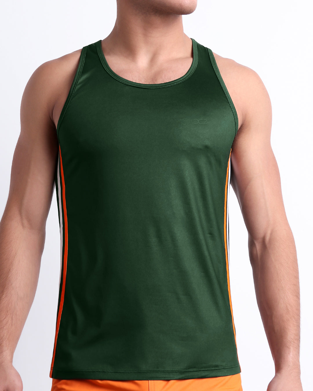 Male model wearing BRAVE GREEN men’s casual Tank Top. A premium quality top in a solid green color with vibrant orange and white stripes on the sides, a men’s beachwear brand from Miami.