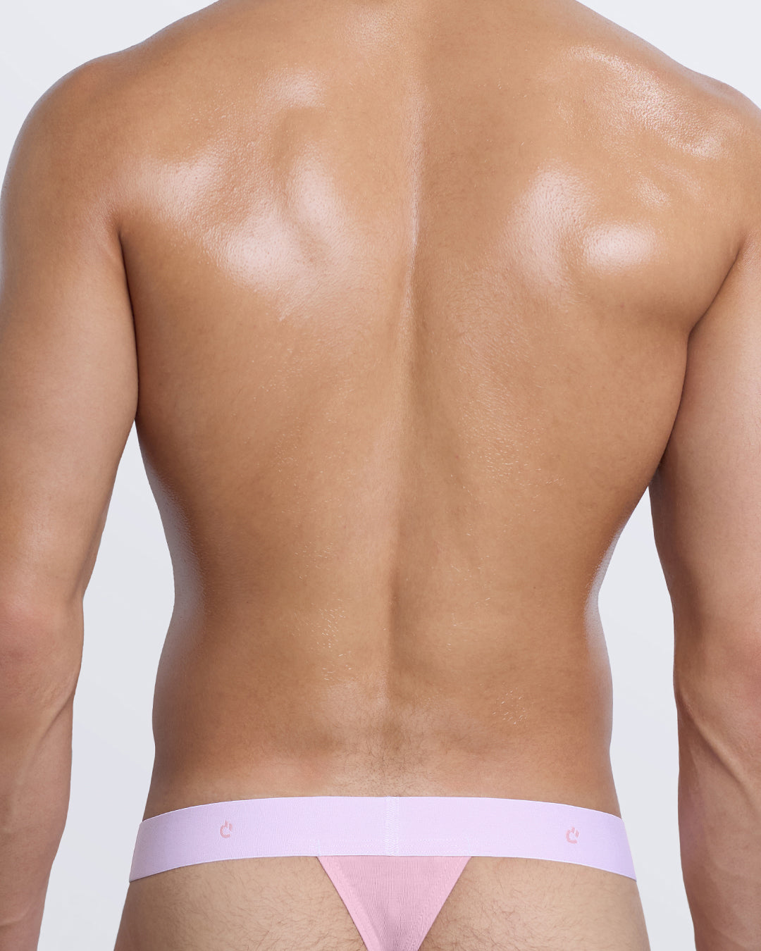 DC2 Modal Thong — back view in pastel pink showing minimal thong fit and tonal elastic with DC2 logo detail.