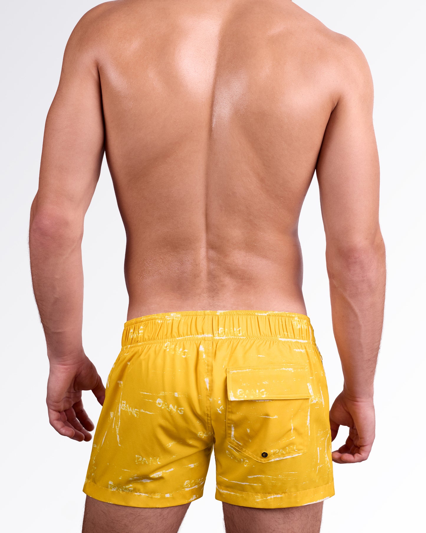 BANG! Miami Brush Rush (Yellow) Flex Shorts — back view highlighting elastic waistband, rear flap pocket, and bold yellow brushstroke design on lightweight quick-dry fabric.