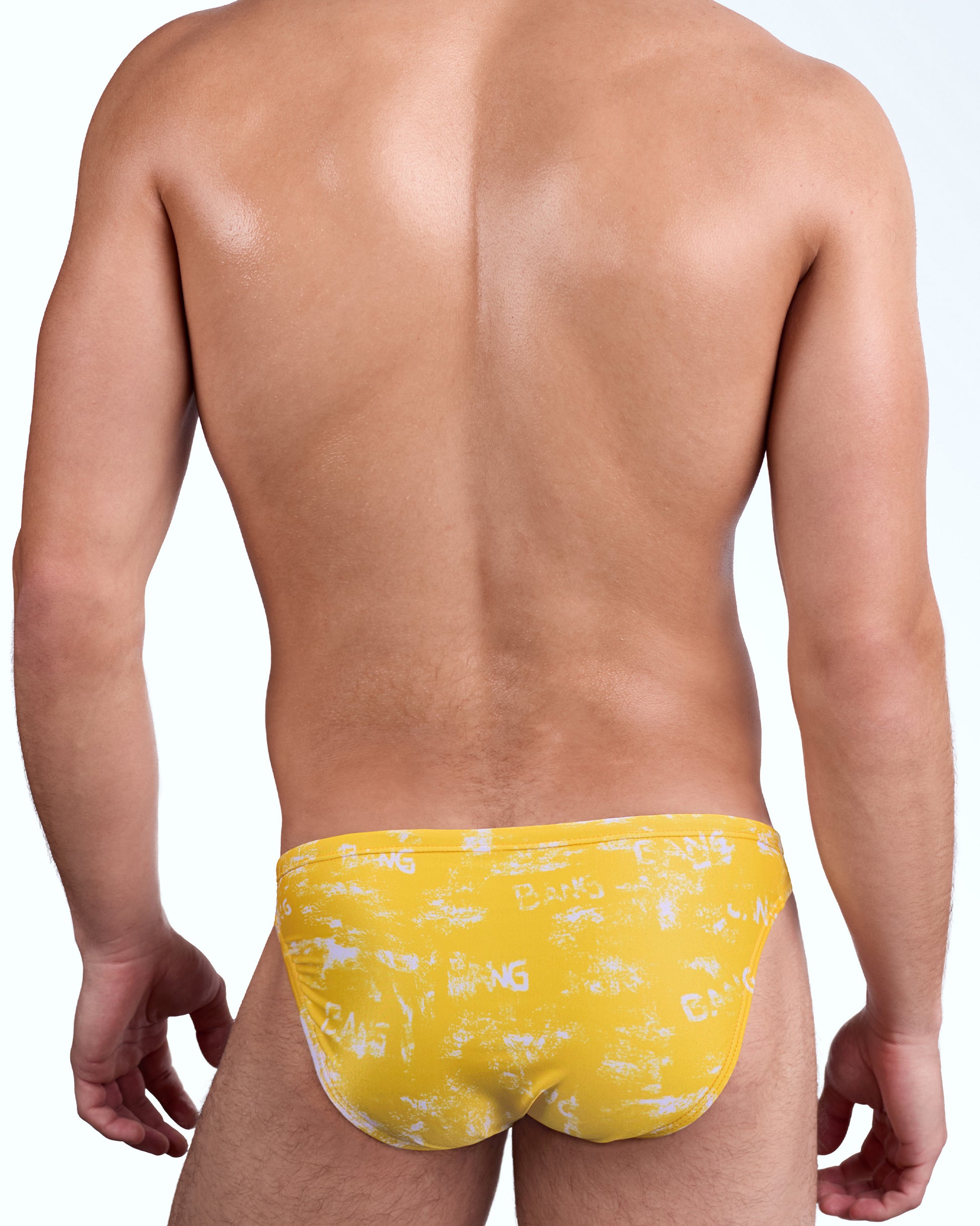 BANG Brush Rush (Yellow) Swim Mini Brief — back view showing full yellow brushstroke print, smooth stretch fabric, and cheeky rear coverage.