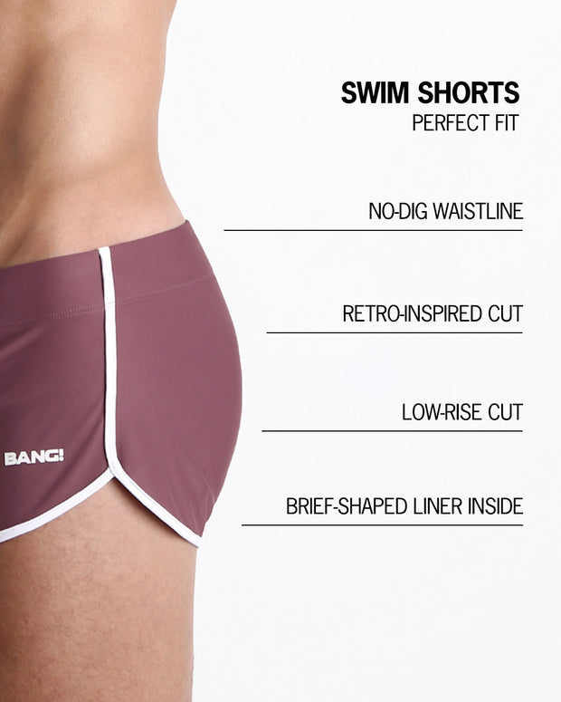 Infographics explaining how perfect the BANG! Clothes Swim Shorts in BUST A MAUVE are. They have a no-dig waistline, retro-inspired cut, low-rise cut, and have a brief-shaped liner inside.