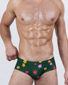BUY MYSELF FLOWERS Swim Briefs – front view of men’s low-rise swimwear with vibrant floral print on green base, featuring classic swim brief cut and snug fit.