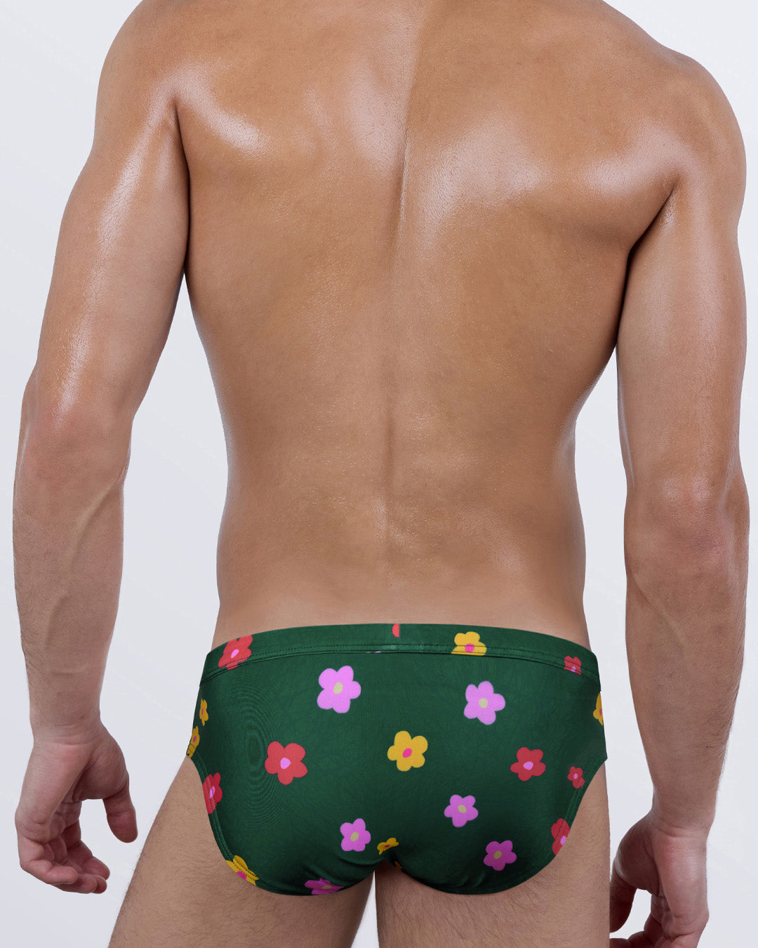 BUY MYSELF FLOWERS Swim Briefs – back view showing full seat coverage and contoured fit, in bold floral print on green swim fabric.