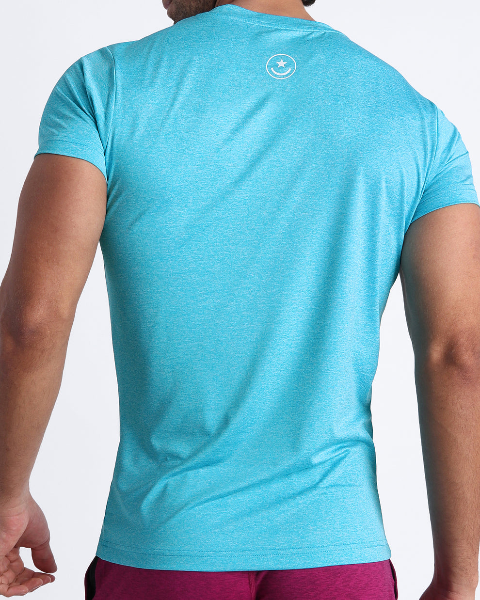 BANG Miami Olympic Blue Fitness T-Shirt — back view showing fitted silhouette, lightweight stretch fabric, and signature logo detail at upper back.