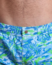 Close-up view of the CAMO POP (BLUE/GREEN) men’s beach shorts, showing custom branded metal button in gold by Bang!