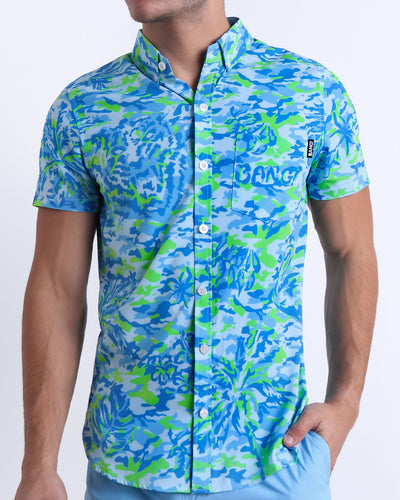 Male model wearing CAMO POP (BLUE/GREEN) men’s sleeveless stretch shirt, a multicolor neon print for men. This premium quality top is by BANG! Clothes, a men’s beachwear brand from Miami.