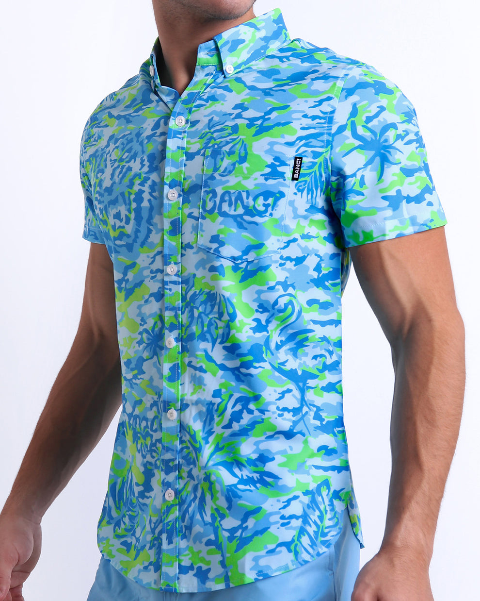 Male model wearing CAMO POP (BLUE/GREEN) men’s sleeveless stretch shirt, a multicolor neon print for men. This premium quality top is by BANG! Clothes, a men’s beachwear brand from Miami.