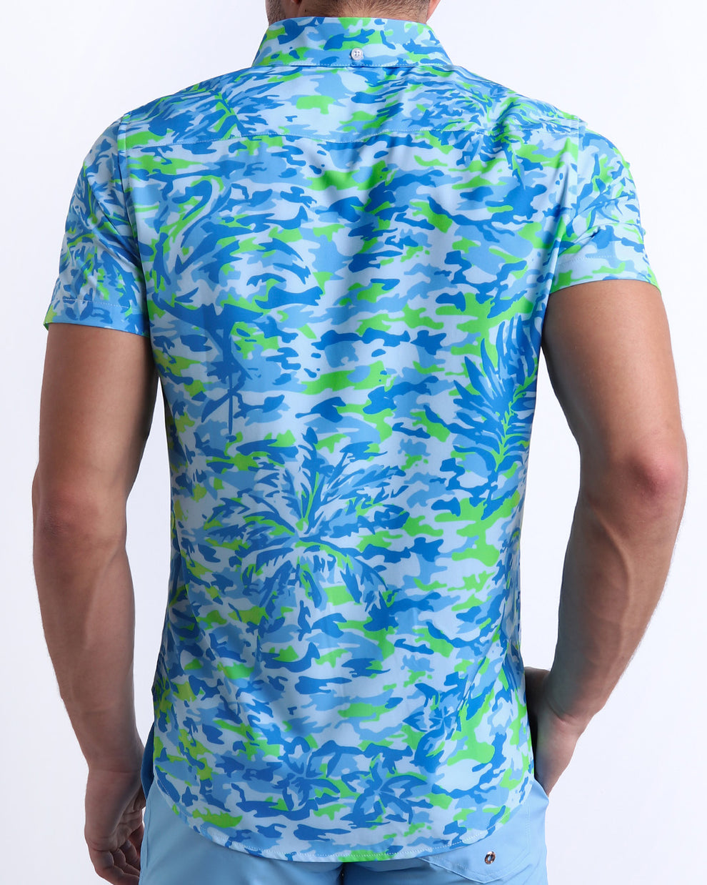 Male model wearing men’s CAMO POP (BLUE/GREEN) men’s Summer button-down in a colorful blue and green neon camo print is designed by BANG! Clothes in Miami.