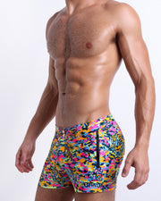 Side view of the CAMO POP (NEON MIX) Summer Beach Shorts with dual zippered-pockets for men featuring a colorful neon camo print are designed by BANG! Clothes in Miami.