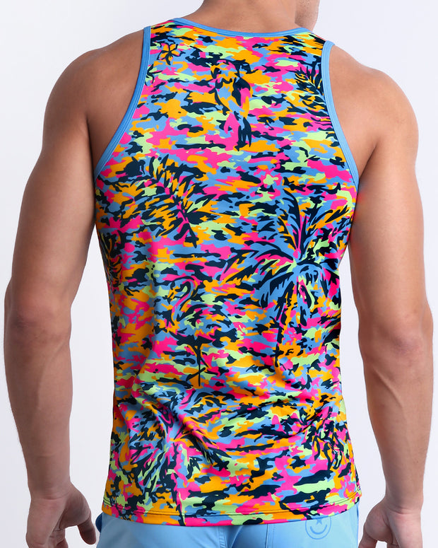 The back view of a Male model wearing a men’s CAMO POP (NEON MIX) Summer Tank Top in a colorful neon camo print with hidden images is designed by BANG! Clothes in Miami.