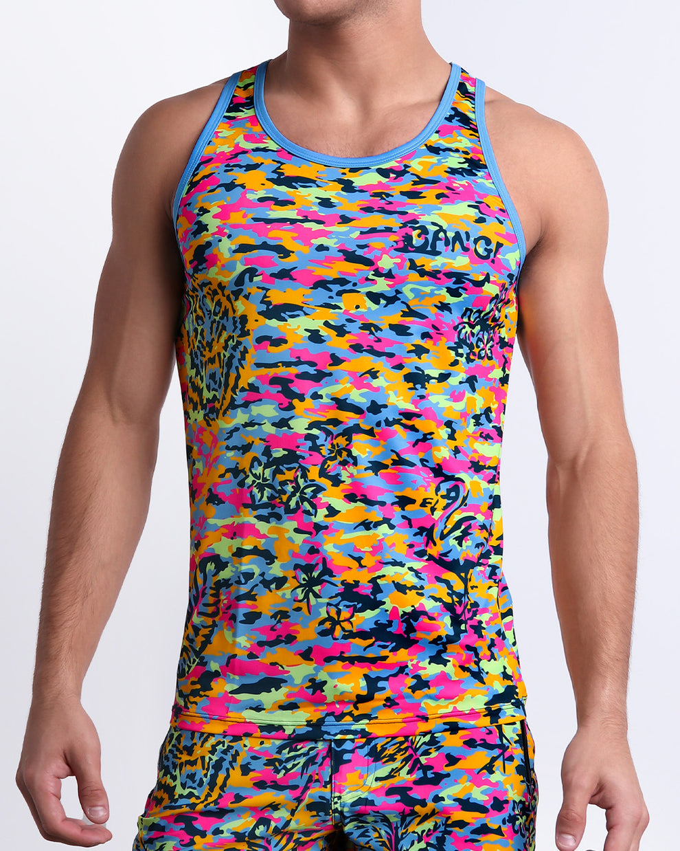 Male model wearing CAMO POP (NEON MIX) beach Tank Top, a multicolor neon print for men. This premium quality top is by BANG! Clothes, a men’s beachwear brand from Miami.