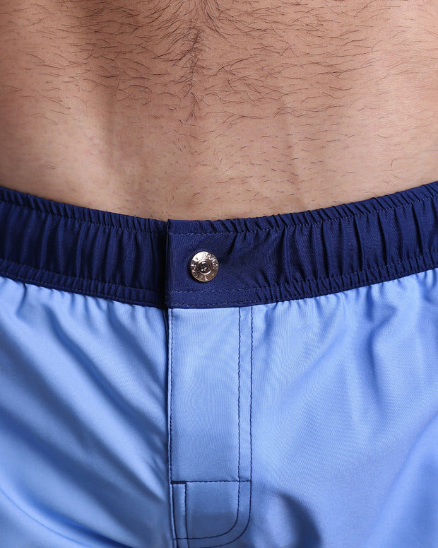 Close-up view of the CASINO ROYALE (BLUE) men’s Mini shorts, showing custom branded metal button in gold by Bang!