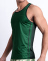 Side view of the CASINO ROYALE (GREEN) for men’s summer casual Tank Top in a color-block green color. Inspired by actor Daniel Craig's iconic blue swim trunks worn in the 2006 film Casino Royale, this top was designed by BANG! Clothes in Miami.