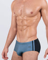 Front angled view of BANG! Casino Royale (Grey) Swim Sunga – sleek Brazilian-style men’s swimwear with steel grey front, black side panels, and a mid-rise cut.