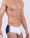 Front angled view of BANG! Casino Royale Swim Sunga in White + Navy Blue – modern Brazilian-style swimwear with contrasting navy side panels and bold white front.