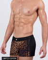 Side view close-up of a male model wearing the Casino Royale (Leopard + Black) Mini Shorts by BANG! Miami. This premium design features four-way stretch fabric, a hidden internal mini-pocket, and a shorter, quad-friendly cut for maximum style and mobility.