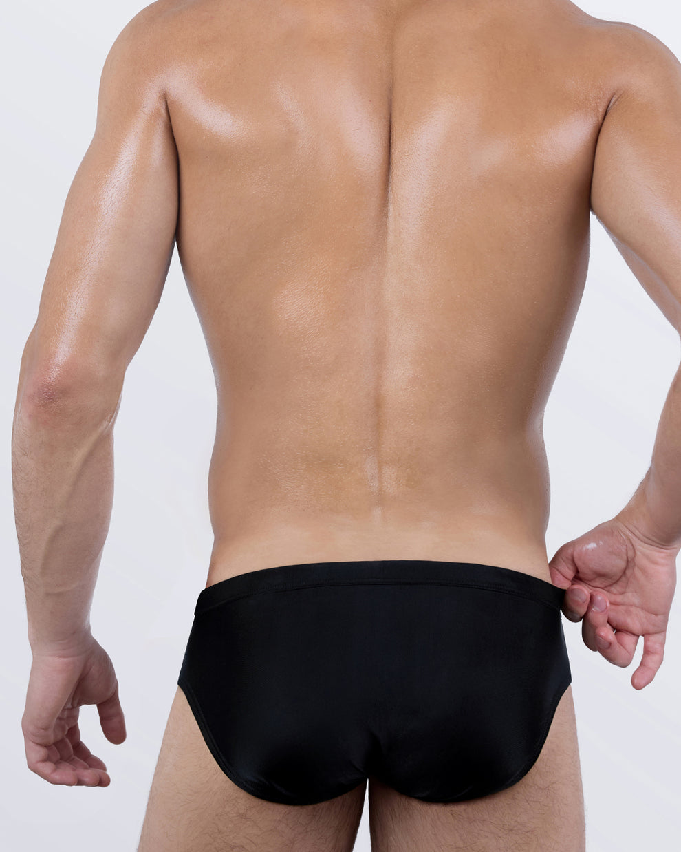 Back view of the CASINO ROYALE Swim Brief in Leopard + Black – minimalist black back panel with a contoured, low-rise fit that defines the silhouette.
