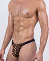 Front-angle view of the CASINO ROYALE (Leopard + Black) Swim Thong by BANG! – wild animal print in deep brown and black tones with sleek black sides for a fierce, exotic look.