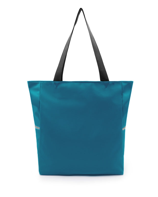 The CHIC TEAL Poolside Tote Bag by DC2 Miami, features a solid teal color. This bag is a perfect companion for beach outings, shopping trips, or everyday use.