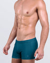 DC2 Chic Teal — model wearing Chic Teal Swim Trunks featuring rich jewel-tone teal color and clean square-cut silhouette.