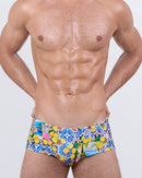 Model wearing DC2 Miami CITRICS CHOICE Swim Sunga – men's Brazilian swimwear with Amalfi Coast-inspired lemon print, vibrant blue tile pattern, and premium fit.