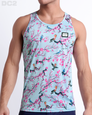 Male model wearing CLOSE TO YOU men’s casual Tank Top. A premium quality top in a stylish exotic birds design in a light blue color with pink flowers, a men’s beachwear brand from Miami.