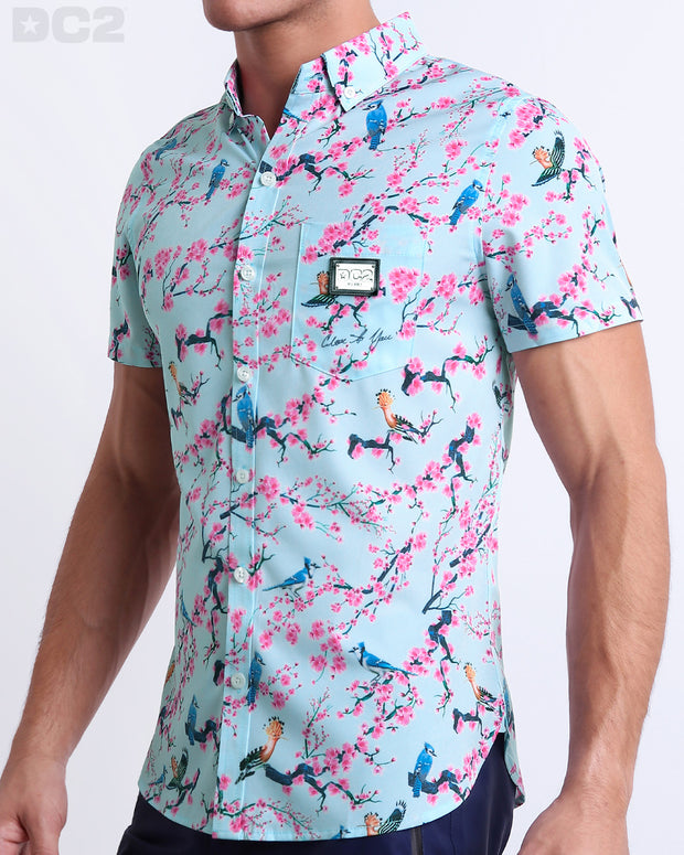 Side view of the CLOSE TO YOU Hawaiian-inspired Stretch Shirt for men in a light blue color with an exotic birds print, complete with a front pocket, made by DC2 a capsule brand by BANG! Clothes in Miami.