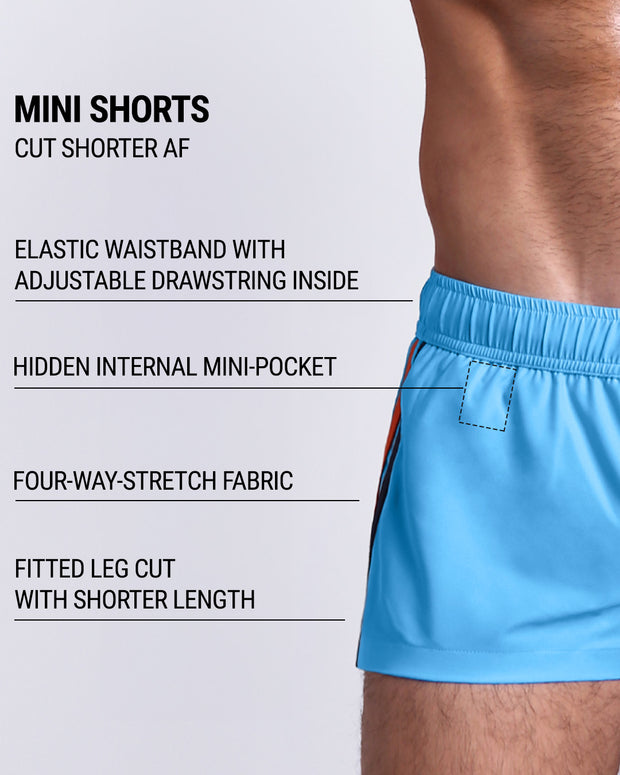 Infographic explaining the many features of the COASTAL BLUE Mini Shorts. These MINI SHORTS have elastic waistband with adjustable drawstring inside, hidden internal mini-pocket, 4-way stretch fabric, and are quad friendly with shorter leg length. 