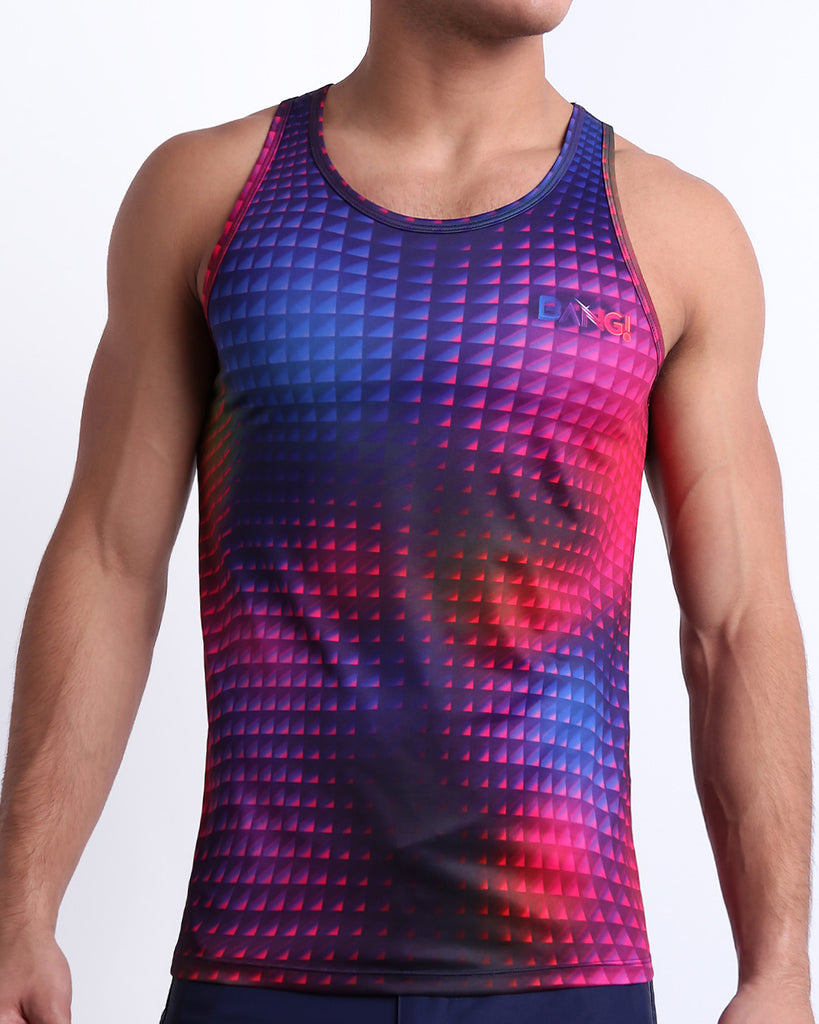 Male model wearing CONFESSION ON A SAND FLR VOL 2 beach tank top, premium quality silky top in red, purple, blue, and pink disco ball print for men. This high-quality Summer top by BANG! Clothes, a men’s beachwear brand from Miami.