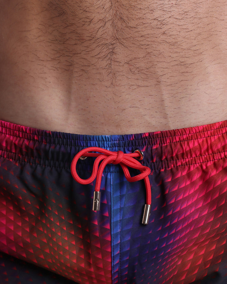 Close-up view of the CONFESSION ON A SAND FLR VOL 2 men’s summer shorts, showing red cord with custom branded golden cord ends, and matching custom eyelet trims in gold.