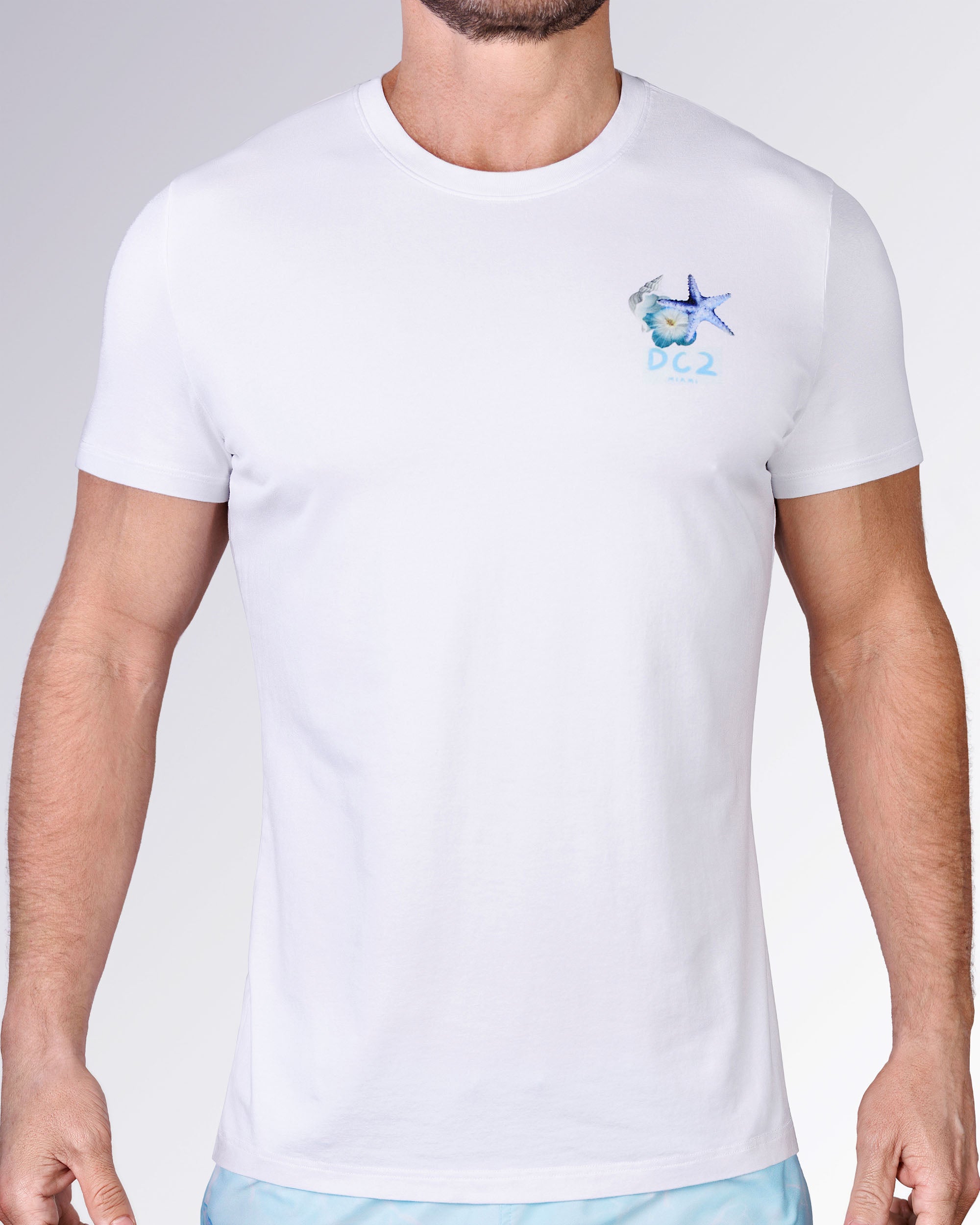 Front view of the Coral Way Cotton Graphic T-Shirt by DC2 Miami, showing the small seashell, flower and starfish chest graphic.
