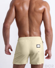 Back view of the CREAM FIELDS beach Resort Shorts in a solid light yellow color, complete with a back pocket, designed by DC2 a capsule brand by BANG! Clothes based in Miami.B3406
