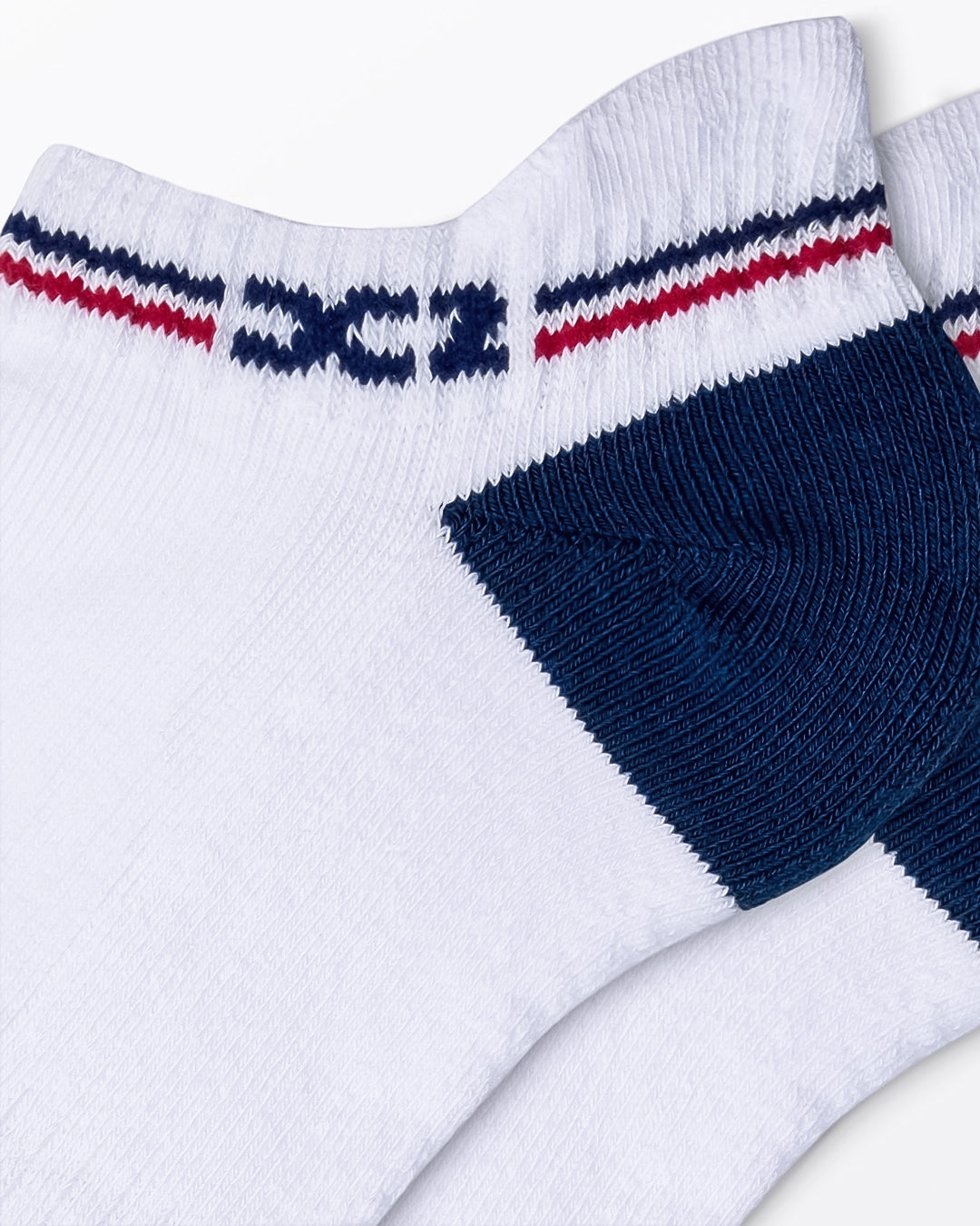 DC2 Daily Ribbed Ankle Socks (White) — close-up of navy heel, ribbed texture, and red/navy cuff stripe with DC2 logo.