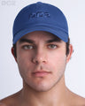 A man wearing the DENIM BLUE - Chillax Cap, a stylish blue color baseball cap made from breathable fabric. The cap features a 3D raised embroidery logo on front and a curved brim for sun protection.