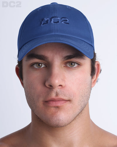 A man wearing the DENIM BLUE - Chillax Cap, a stylish blue color baseball cap made from breathable fabric. The cap features a 3D raised embroidery logo on front and a curved brim for sun protection.