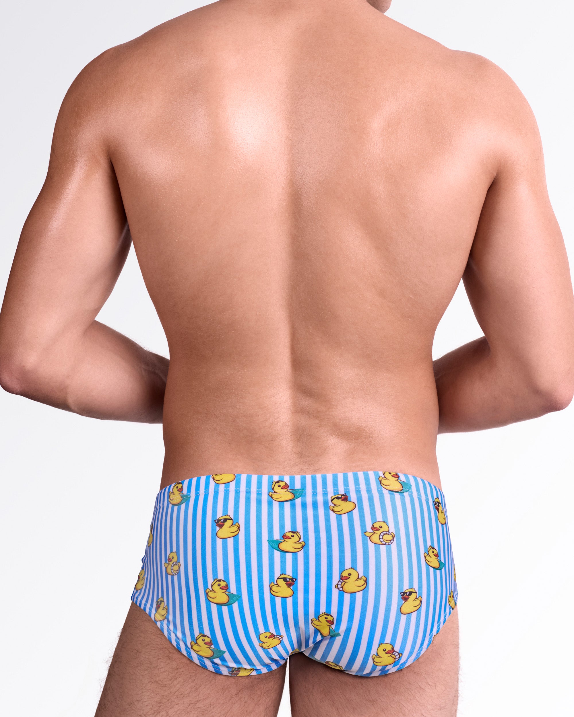 BANG Ducks Just Wanna Have Fun Swim Sunga — back view showcasing allover striped pattern with scattered rubber duck illustrations and smooth body-contouring fit.
